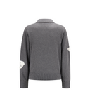 A dark gray knit cardigan sweater shown from the back, featuring a collar, ribbed cuffs and hem, and two contrasting white circular patch details on the sleeves.